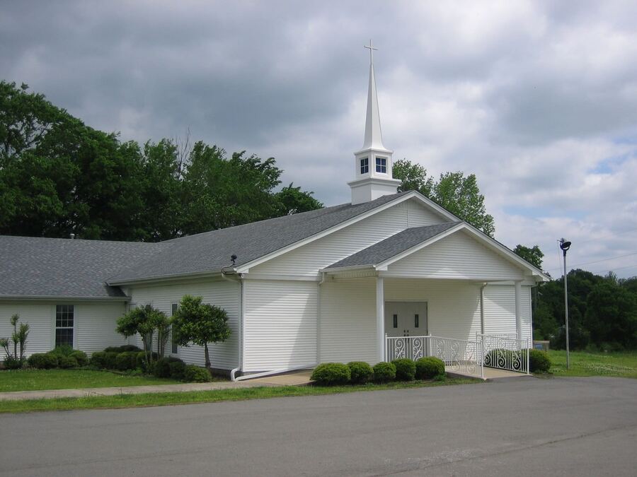 The white Providence Baptist Church building with its steeple, on N. Fourche Avenue in Perryville.
