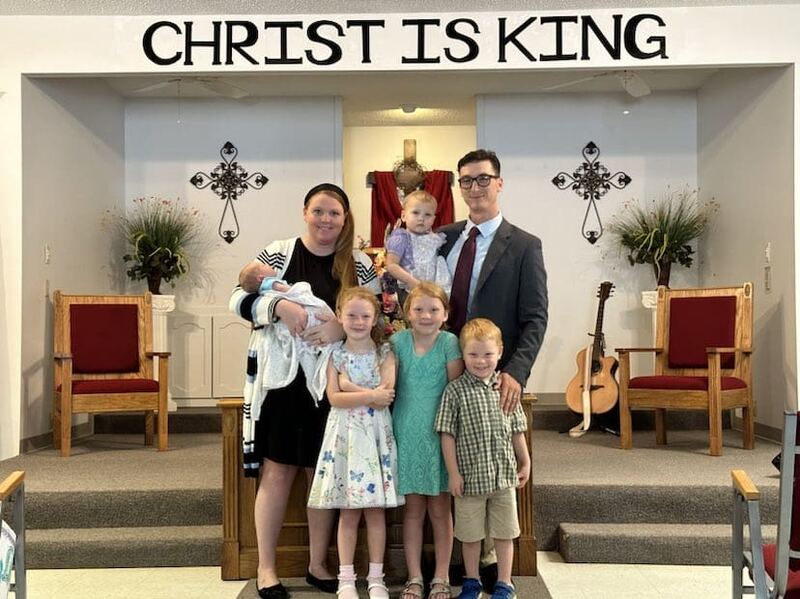 Gunner Madewell and his wife Liz with their five children at the front of the church.